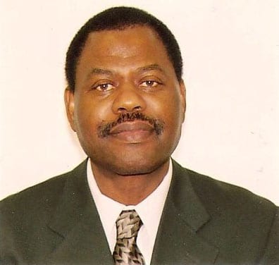 Headshot of man in dark suit and tie